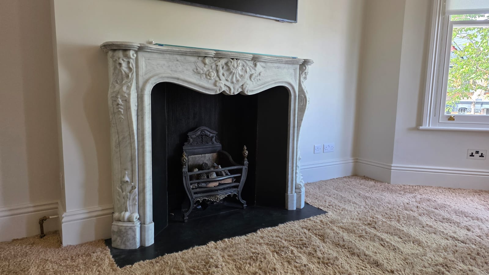 Restored period living room with ornate marble fireplace after a full DAB renovation